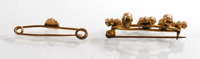 Lot 911 - A yellow metal bar brooch set seed pearls and...