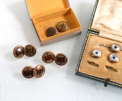 Lot 914 - Six git metal dress studs, each decorated with...