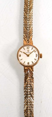 Lot A ladies 9ct yellow gold wristwatch by Omega,...