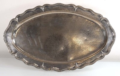 Lot 227 - A hammered metalware tray of oval form, the...