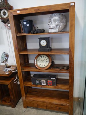 Lot 1065 - Modern Indian Gum shelving unit with 2 lower...