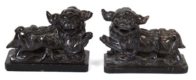 Lot 119 - A pair of soapstone figures modelled as temple...