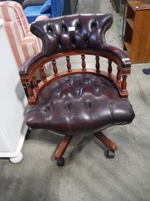 Lot 1093 - Captains style desk chair upholstered in a red...