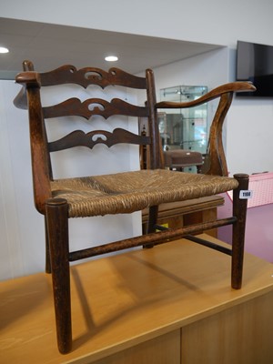 Lot 1108 - Childs oak framed rush seated armchair