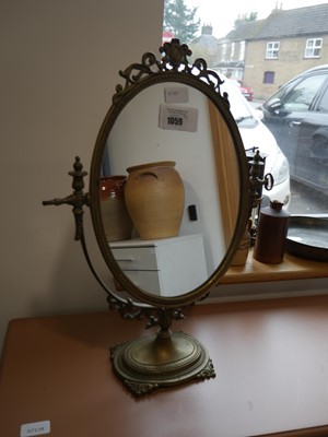 Lot 1059 - Ornate free standing oval mirror on stand