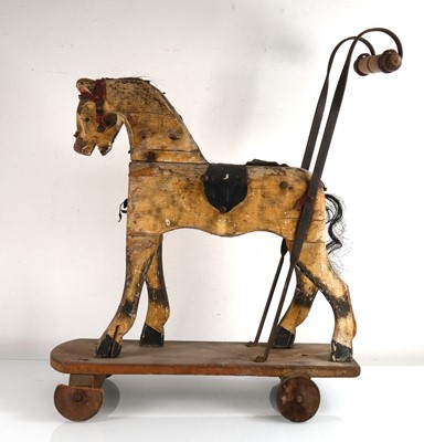 Lot 147 - A Victorian painted wood push along horse, h....