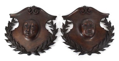 Lot 147 - A pair of figural oak wall plaques modelled...