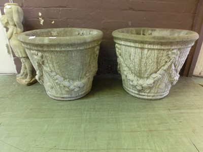 Lot 16 - A pair of garden urns with swag design to body