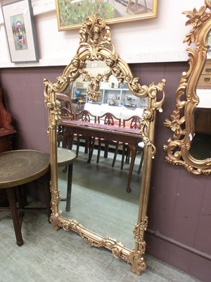 Lot 61 - An ornate gilt framed over mantle mirror