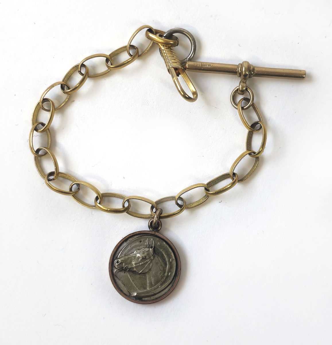 Lot 430 - A part yellow metal albert chain suspending a...