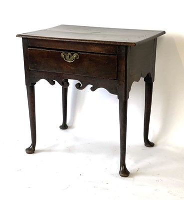 Lot 48 - A Georgian oak lowboy, the chamfered surface...