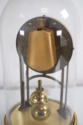 Lot 56 - An American brass anniversary clock under a...