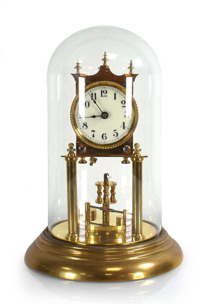 Lot 57 - A German brass anniversary clock under a glass...