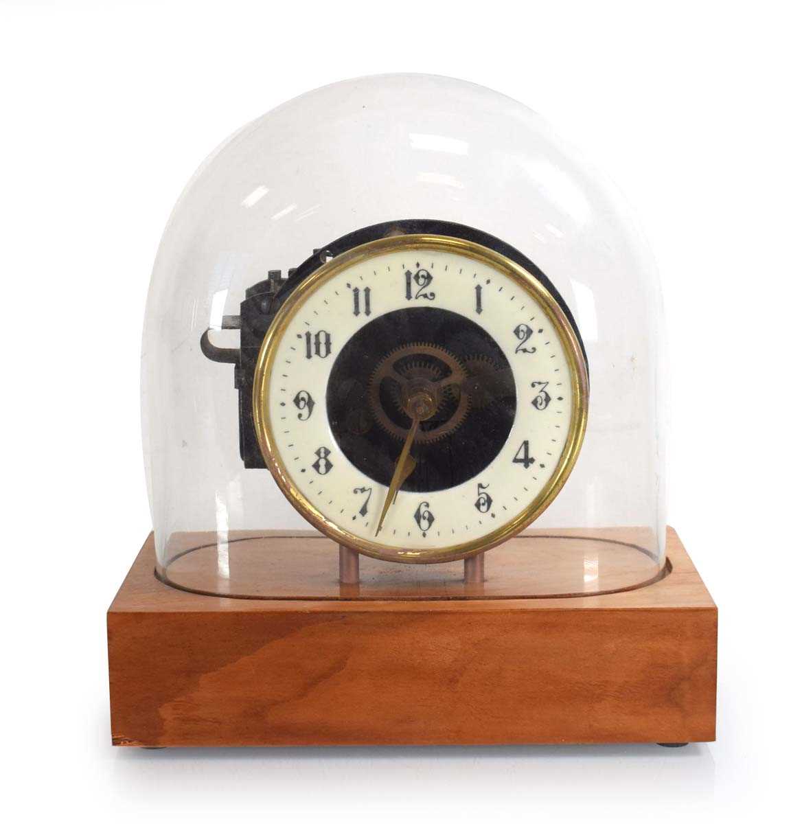 Lot 58 - A Swiss made electric table clock under a...