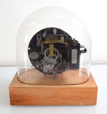 Lot 58 - A Swiss made electric table clock under a...