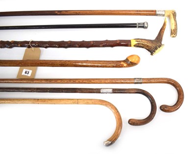 Lot 63 - A group of seven walking sticks including five...