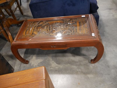 Lot 1011 - Heavily carved glass top coffee table