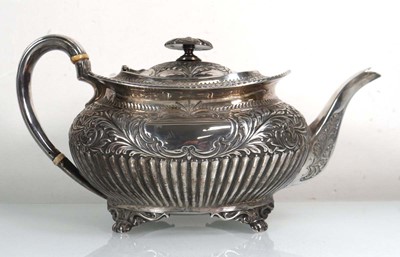 Lot 398 - A Victorian silver repousse decorated teapot...