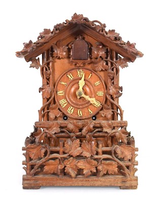 Lot 106 - A 20th century Black Forest style cuckoo clock,...