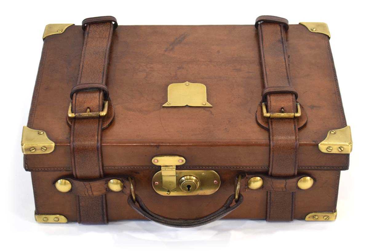Lot 17 - A leather-covered cartridge case/magazine with...
