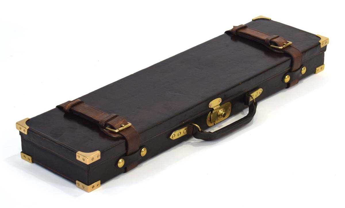 Lot 18 - A leather-covered and brass mounted gun case,...