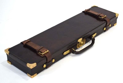 Lot 18 - A leather-covered and brass mounted gun case,...