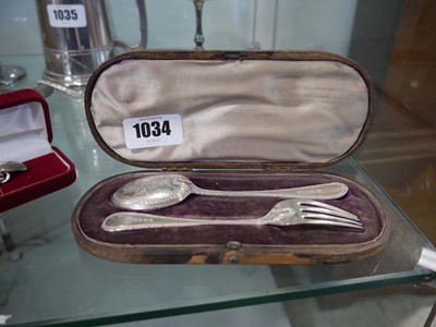 Lot 1034 - 2 cased silver pieces; a fork and spoon set...