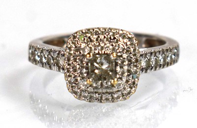 Lot 733 - An 18ct white gold halo ring set princess and...