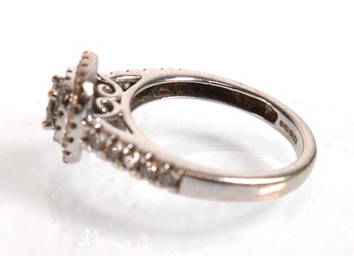 Lot 733 - An 18ct white gold halo ring set princess and...