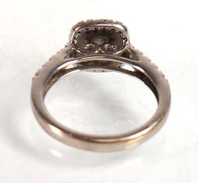 Lot 733 - An 18ct white gold halo ring set princess and...