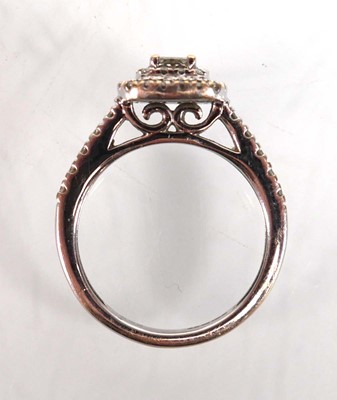 Lot 733 - An 18ct white gold halo ring set princess and...