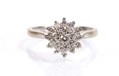 Lot 734 - An 18ct white gold cluster ring set small...