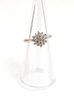 Lot 734 - An 18ct white gold cluster ring set small...