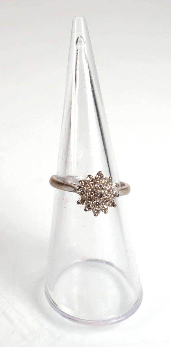 Lot 734 - An 18ct white gold cluster ring set small...