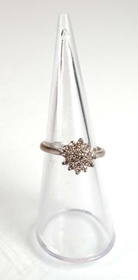 Lot 734 - An 18ct white gold cluster ring set small...