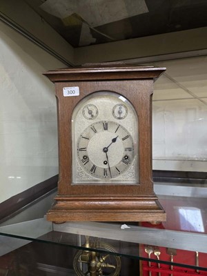 Lot 300 - A 20th century mantel clock on bun feet