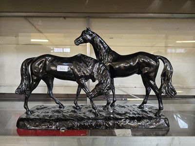 Lot 301 - A black painted moulded figural group of two...