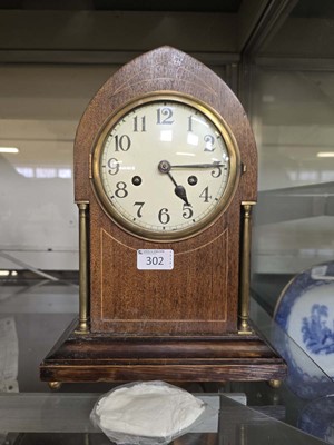 Lot 302 - An early 20th century arch topped mantel clock...