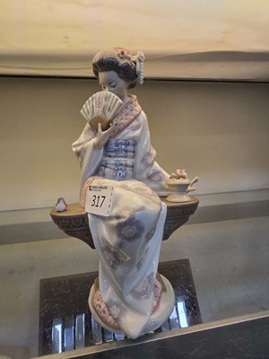 Lot 317 - A Lladro ceramic figure of a seated lady with...