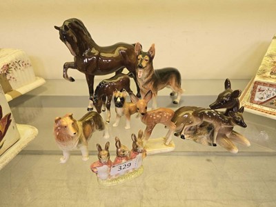 Lot 329 - An assortment of eight ceramic figurines to...