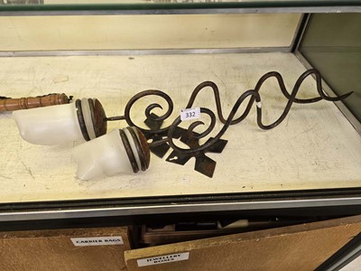 Lot 332 - A pair of wrought iron wall mounted candle...