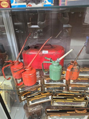 Lot 369 - A red metal petrol can along with four old oil...