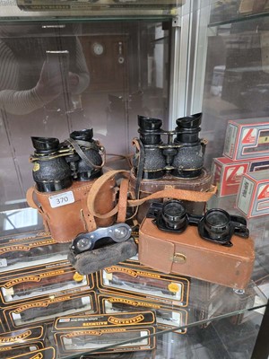 Lot 370 - Two cased sets of binoculars along with a...