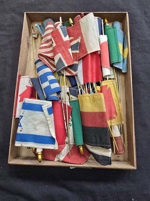 Lot 391 - A box containing a quantity of small flags on...
