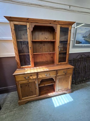 Lot 17 - A modern pine dresser having a raised top...