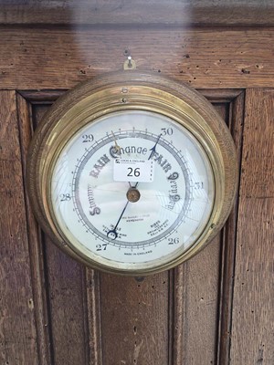 Lot 26 - A oak mounted brass barometer