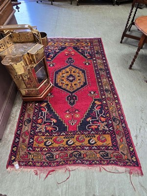 Lot 29 - An eastern red ground rectangular rug