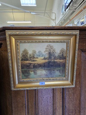 Lot 34 - A gilt framed oil on board of a lake scene...