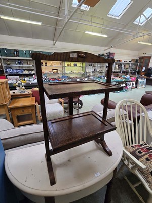 Lot 70 - A mid 20th century oak two tier folding cake...