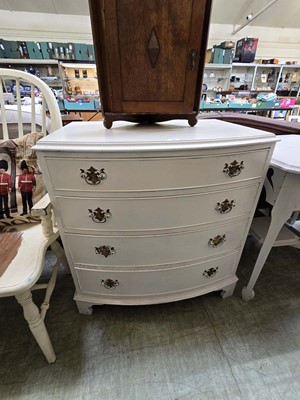 Lot 74 - A cream painted bow fronted chest of four drawers